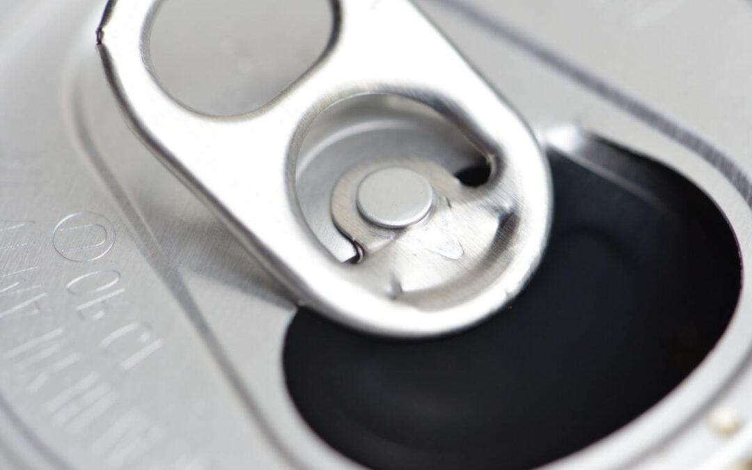 在软饮料罐的环上开孔的原因是固定片，这是一种可以将罐盖固定到位的装置。